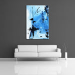 An abstract painting featuring light blue, white, and black acrylic paint. Displayed on a wall.