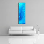 A modern abstract painting featuring the colours  light and dark blue. Displayed vertically on a wall.