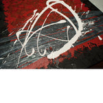 Close up image of a red, black, white and grey contemporary abstract painting
