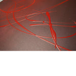 A close up photo of a modern abstract painting featuring burgundy..