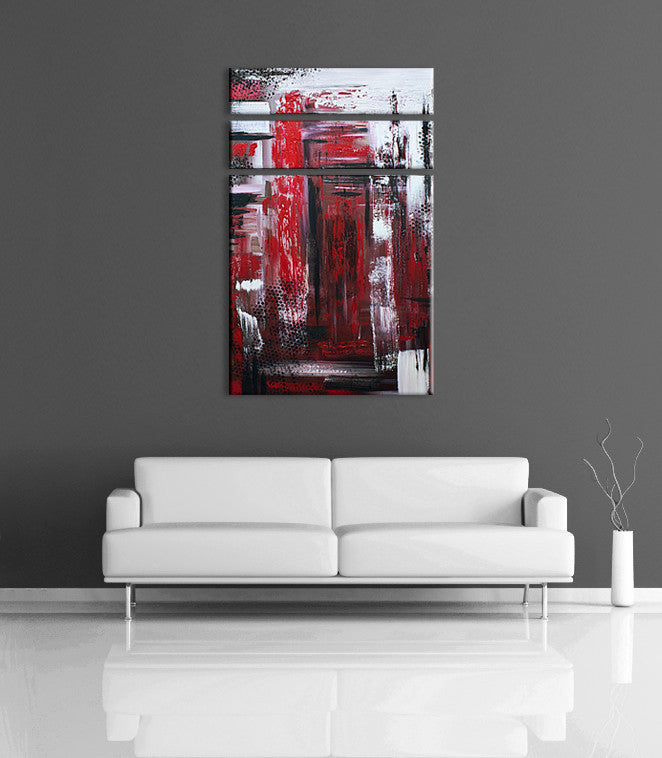Abstract color art - Image of a 3 panel, red, black and white abstract acrylic painting on a grey wall, above a couch