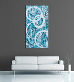 Image of a large, tall, light blue and turquoise abstract, acrylic painting featuring modern white circles. The painting is on a grey wall above a couch.