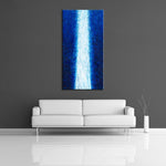 A modern abstract painting featuring the colours blue and white. Displayed on a wall.