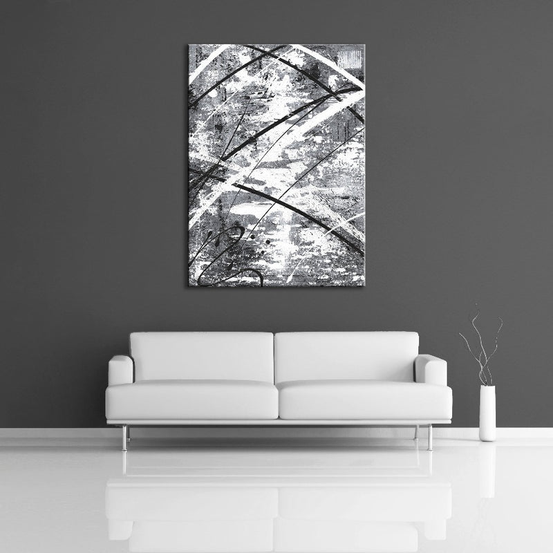 A modern abstract painting featuring the colours gray, white and black. Displayed on a wall.