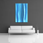 A modern abstract painting featuring the colours dark and light blue with streaks of white. Displayed on a wall.