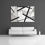 A abstract painting featuring strong black lines over the colours white and gray. Displayed on a wall.