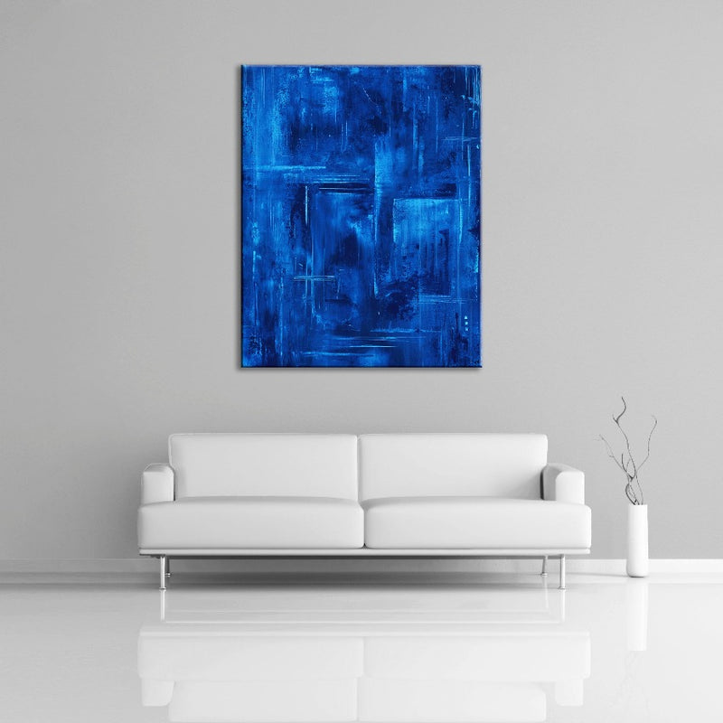 A modern abstract painting featuring the colour blue. Displayed over a couch.