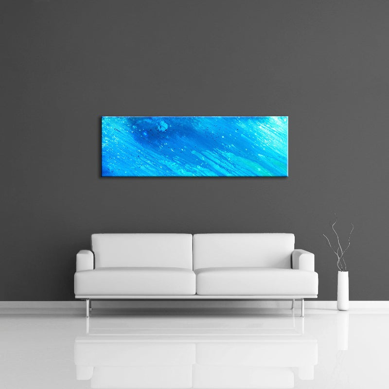 A modern abstract painting featuring the colours  light and dark blue. Displayed over a couch