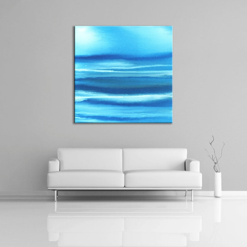 A modern abstract painting featuring the colours light and dark blue with a little white. Displayed over a couch.