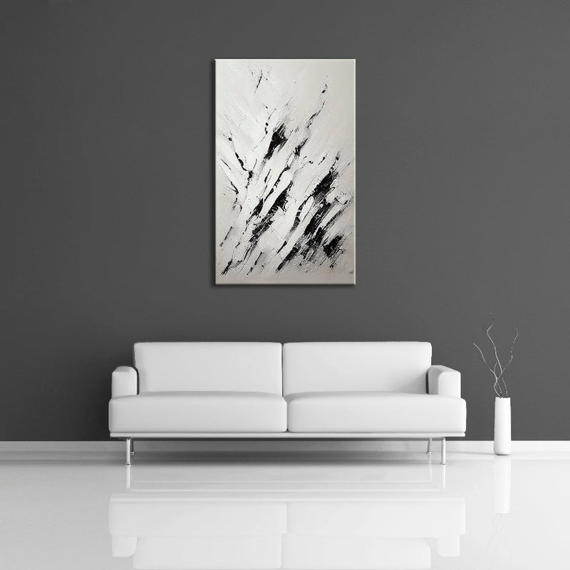 A modern abstract painting featuring the colours black and white. Displayed on a wall.