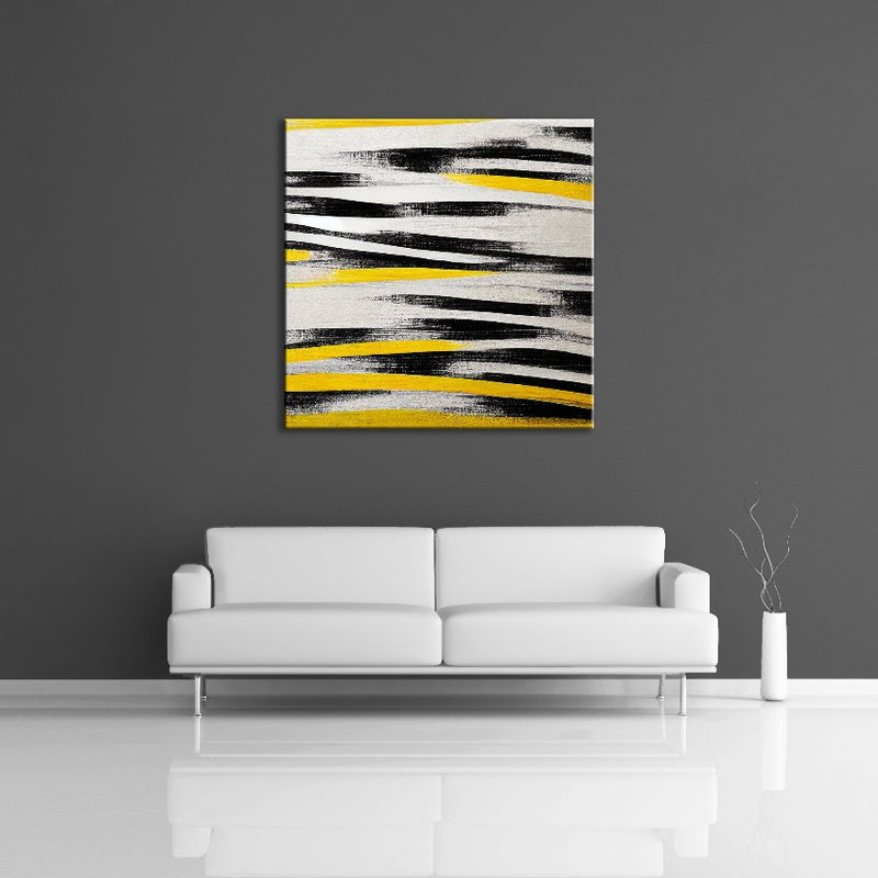 An abstract painting featuring yellow, black and white.  Displayed on a wall.